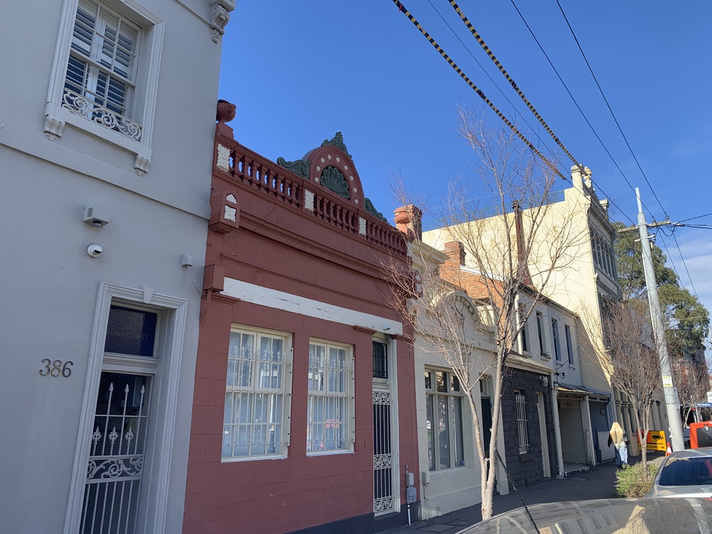384 Drummond Street Carlton Victorian terrace with overhead power lines running across the frontage — a Melbourne example where electricity distributor permit requirements apply before exterior painting begins