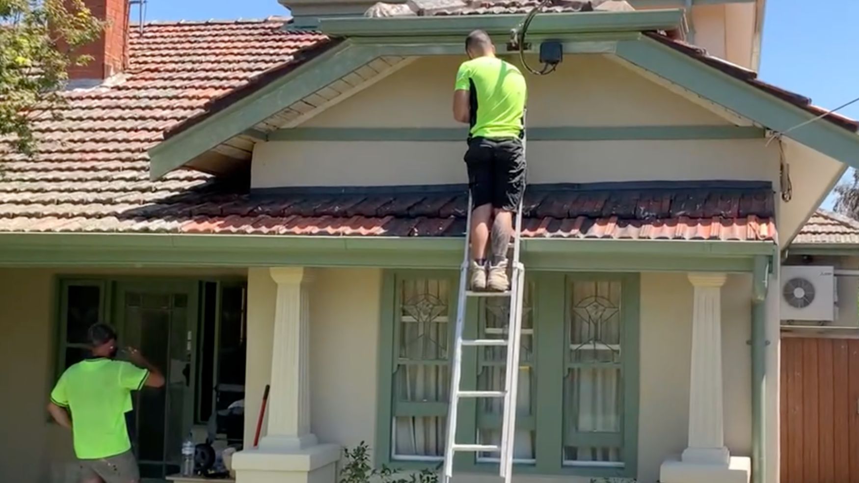 Melbourne City Maintenance painters working at the eaves and gable end of a Thornbury home